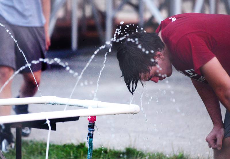 Forreston football player Micah Nelson cools off following a scrimmage on the Cardinals football field on Thursday, July 27.