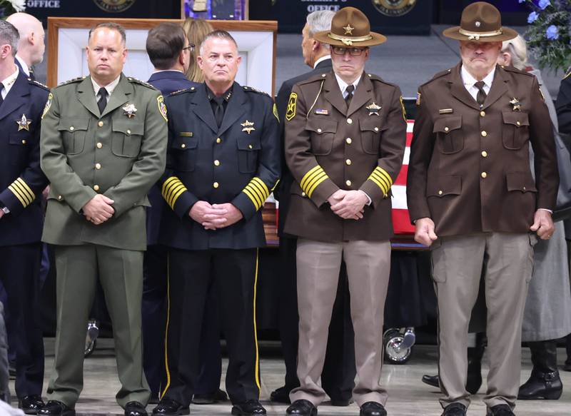 Law enforcement officers stand guard in front of the casket for fallen DeKalb County Sheriff’s Deputy Christina Musil Thursday, April 4, 2024, during her visitation and funeral in the Convocation Center at Northern Illinois University. Musil, 35, was killed March 28 while on duty after a truck rear-ended her police vehicle in Waterman.