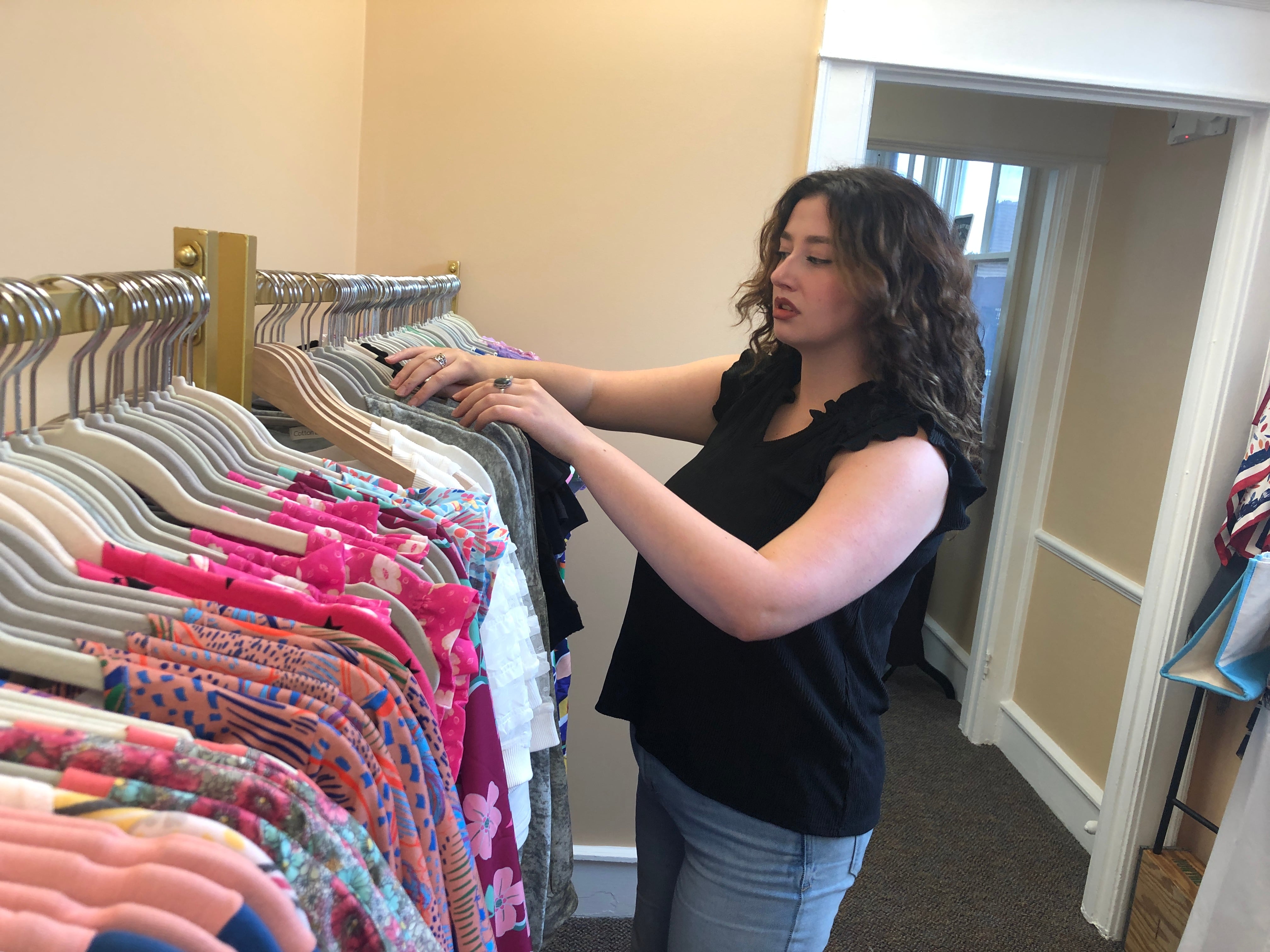 Skyler Kunetka organizes clothing at Wild Hunny Boutique on Friday, Aug. 2, 2024, a day before it is set to open in downtown McHenry. No clothing in the store is priced for more than $33, owner Laura Taubery said.