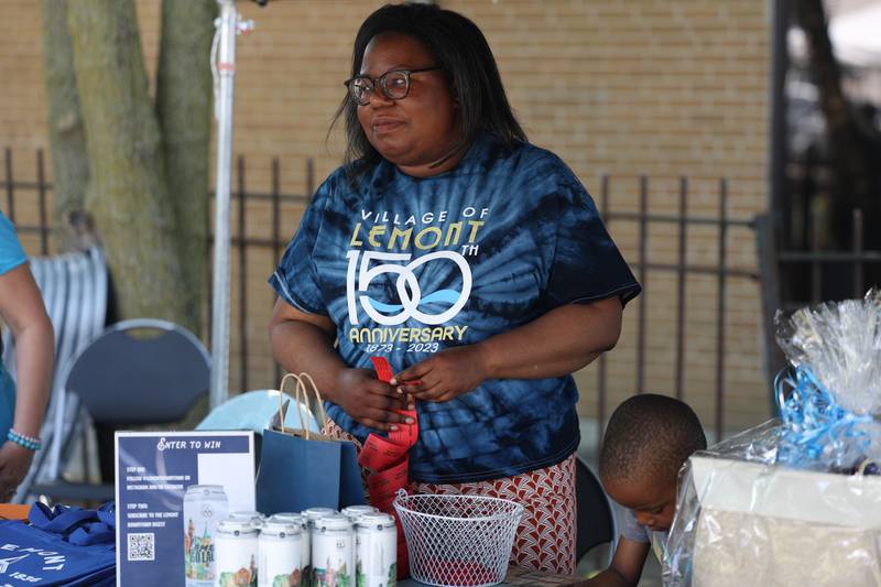 Christian Gist, who does marketing and branding for Lemont, sales raffle tickets at the Lemont 150th Anniversary Commemoration on Friday, June 9, 2023 in downtown Lemont.