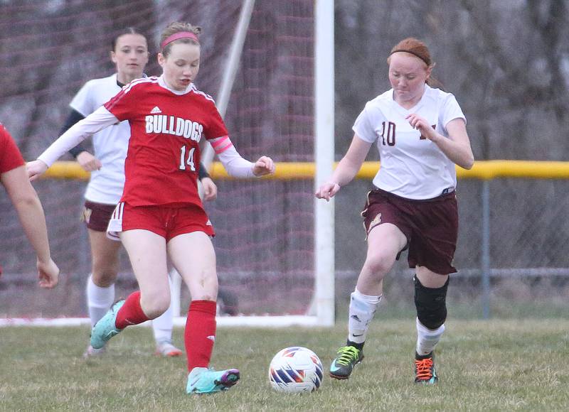 Streator's Bridget McGurk kicks the ball away from Morris's Danica Martin on Monday, March 25, 2024 at the James Street Recreation Area in Streator.
