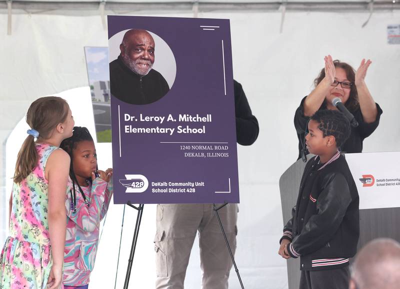 DeKalb School District 428 Superintendent Minerva Garcia-Sanchez (right) applauds as the name of the new school is unveiled  Thursday, April 11, 2024, by students who will be among the first to attend during the groundbreaking ceremony for Dr. Leroy A. Mitchell Elementary School. The school will be located at 1240 Normal Road in DeKalb.