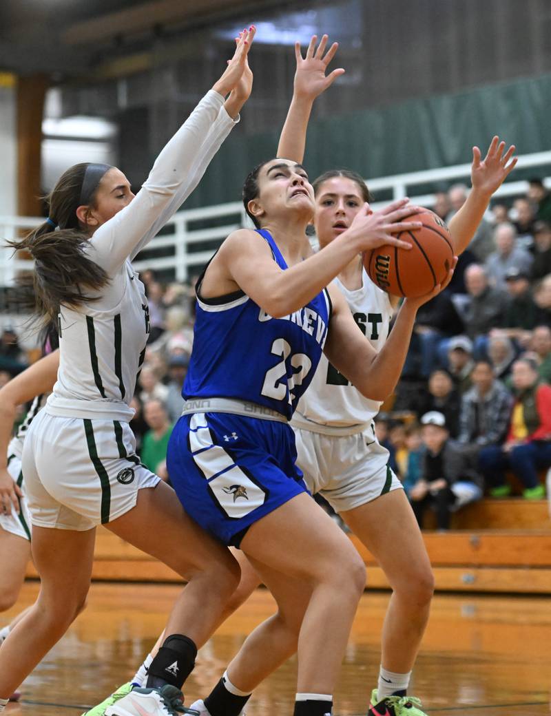 Geneva’s Leah Palmer makes a move against Glenbard West’s Hannah Roberts, left, and Mya Austin during the Glenbard West Class 4A girls basketball regional final on Thursday, Feb. 15, 2024 in Glen Ellyn.