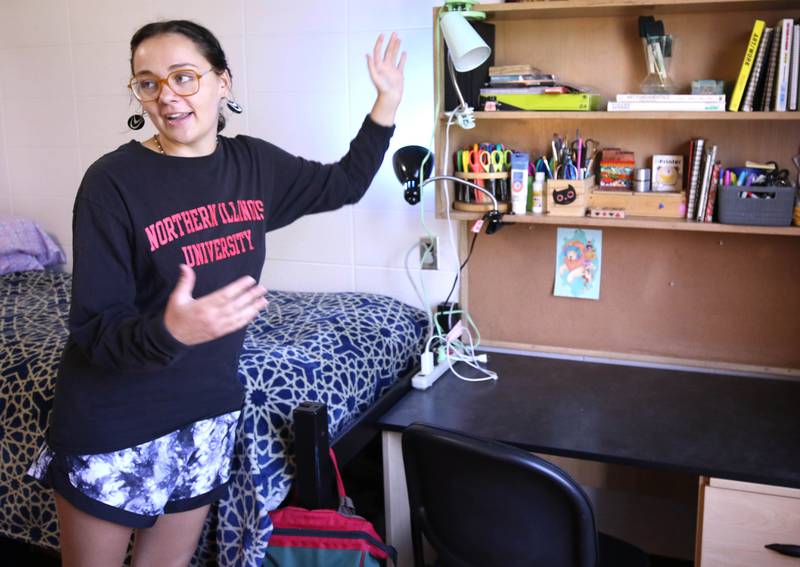 Eleanor Gentry, a Northern Illinois University senior from Peoria and community advisor at Neptune Hall East, talks Friday, Aug. 11, 2023, in her dorm room at NIU, about some of the essential items new students should remember to bring when they move into their residences for the school year.