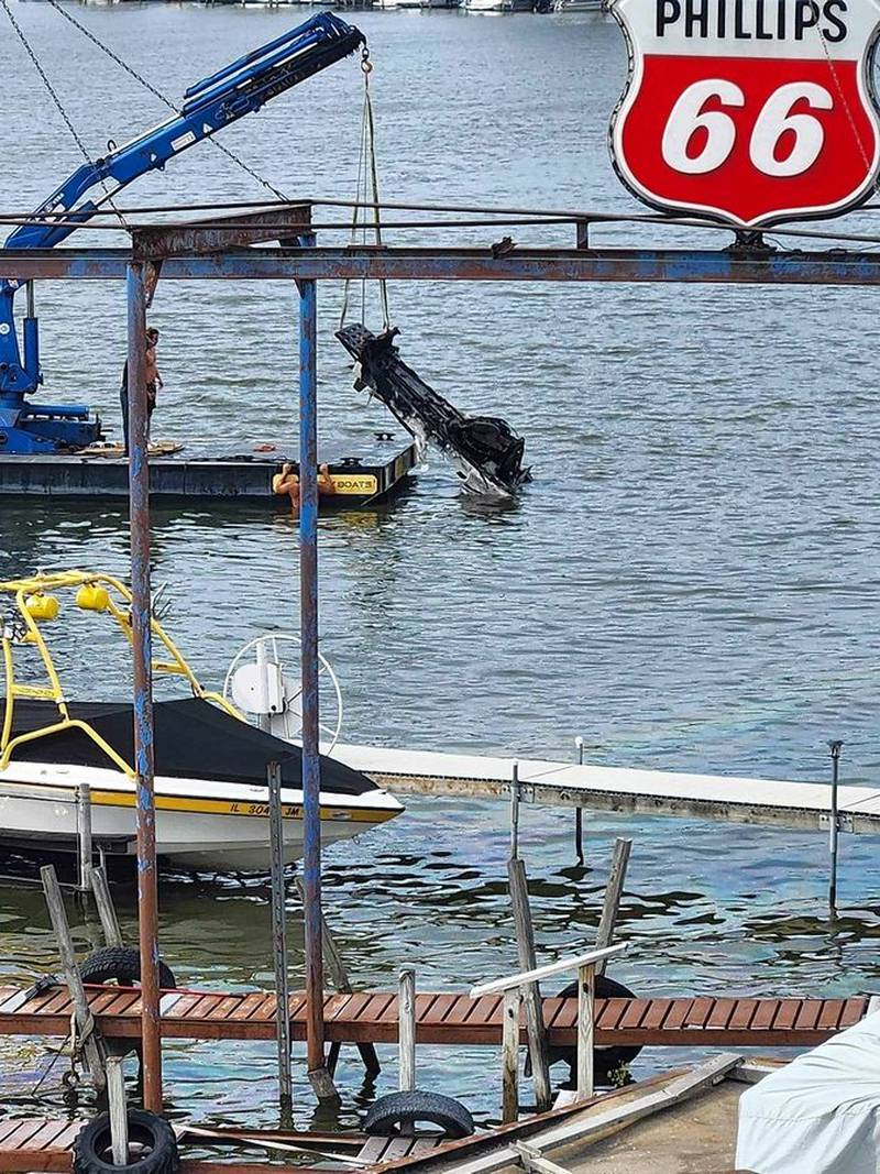 A boat is lifted up after it was on fire and sunk earlier the afternoon of Sunday, Aug. 6, 2023, in Pistakee Lake.