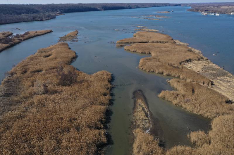 An aerial view of Delbridge Island looking west toward the Starved Rock Lock and Dam on Tuesday, Feb. 13, 2024 near Starved Rock State Park. The Starved Rock Breakwater project is a habitat restoration effort designed to restore submerged aquatic vegetation in the Illinois River, Starved Rock Pool. It will increase the amount and quality of resting and feeding habitat for migratory waterfowl and improve spawning and nursery habitat for native fish.
Construction of the breakwater will involve placement of riprap along northern edge of the former Delbridge Island, adjacent to the navigation channel between River Mile 233 and 234. The breakwater structure will be approximately 6,100 feet long and constructed to a design elevation 461.85 feet, providing adequate protection to allow for submerged aquatic vegetation growth.
The estimated total cost of this project is between $5 and $10 million.