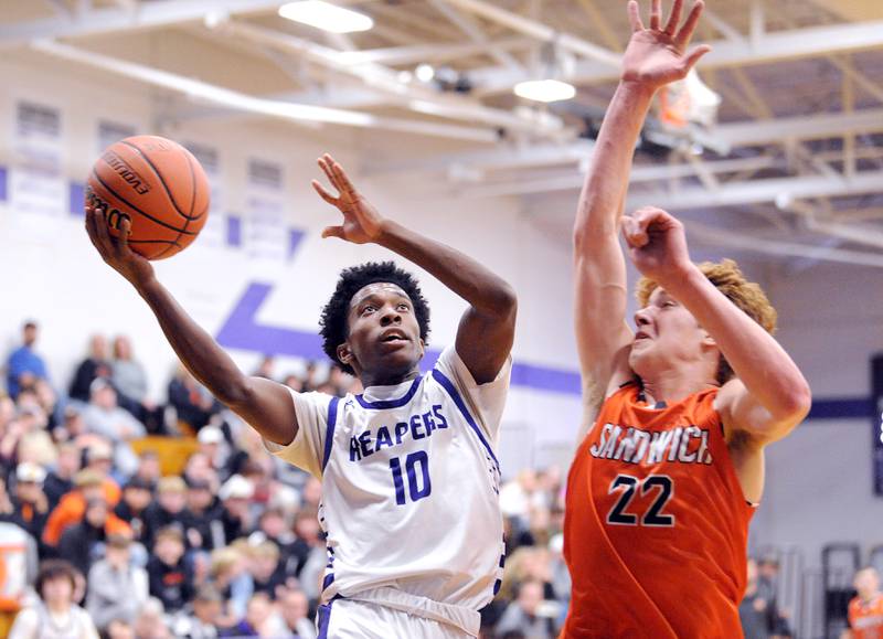 Plano's Davione Stamps (10) drives for a shot against Sandwich defender Dom Rome (22) during a varsity basketball game at Plano High School on Tuesday, Dec. 5, 2023.