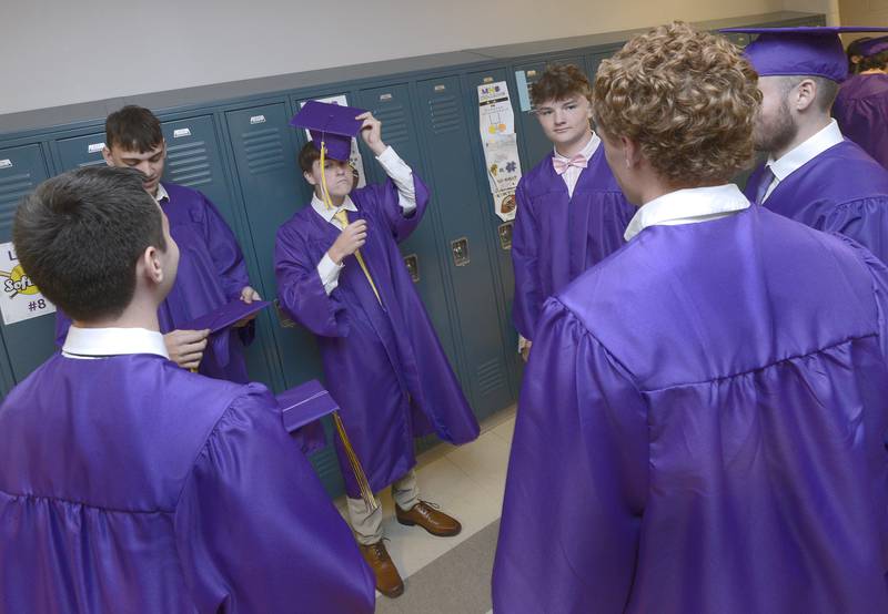 Students ready themselves in the hallway at Mendota High School Saturday  minutes before the class of 2024 graduation ceremony.