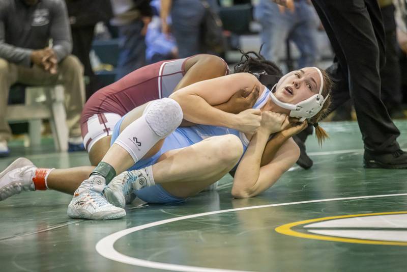 Teagan Aurich of Plainfield South High School (blue) wrestles undefeated Maryam Ndiaye of Moline High School in the 155 weight class during IHSA girls sectionals on February 10, 2024 at Geneseo High School.