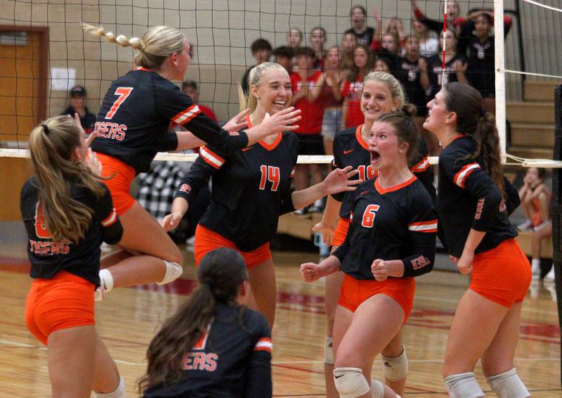 Crystal Lake Central’s Tigers celebrate during their win in a Fox Valley Conference volleyball match on Tuesday, Aug. 27, 2024, at Huntley High School.