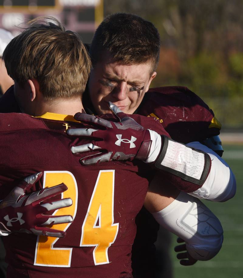 Montini's Jaxon Lane, right, hugs teammate George Asay after the Broncos lost to Byron 26-20 during the Class 3A semifinal game in Lombard Saturday.