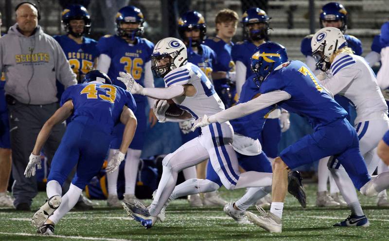 Geneva's Michael Rumoro (20) moves upfield trying to avoid Lake Forest's Miles Specketer (43) during the IHSA Class 6A playoff game Friday November 3, 2023 in Lake Forest.