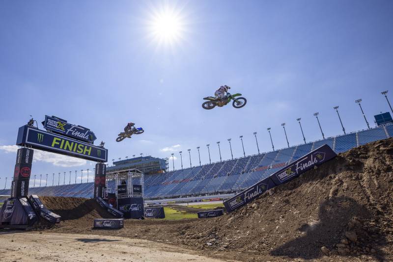 Two riders cross through the finish line jump during open practice day for the Super Motocross Finals at Chicagoland Speedway on September 15, 2023.