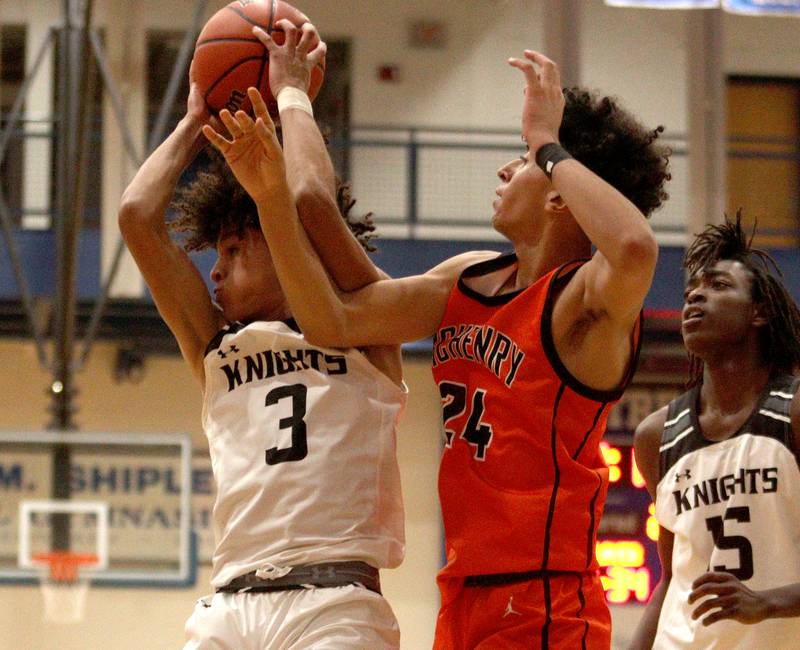 Kaneland’s Evan Frieders, left, battles McHenry’s Adam Anwar in Hoops for Healing basketball tournament championship game action at Woodstock Wednesday.