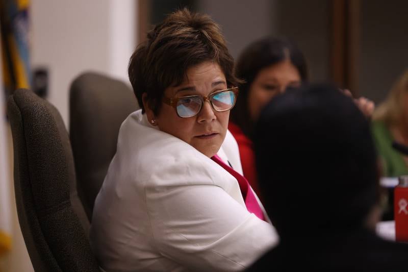 Will County Executive Jennifer Bertino-Tarrant speaks with another board member at the Will County board meeting on Thursday, Aug. 17, 2023 in Joliet.