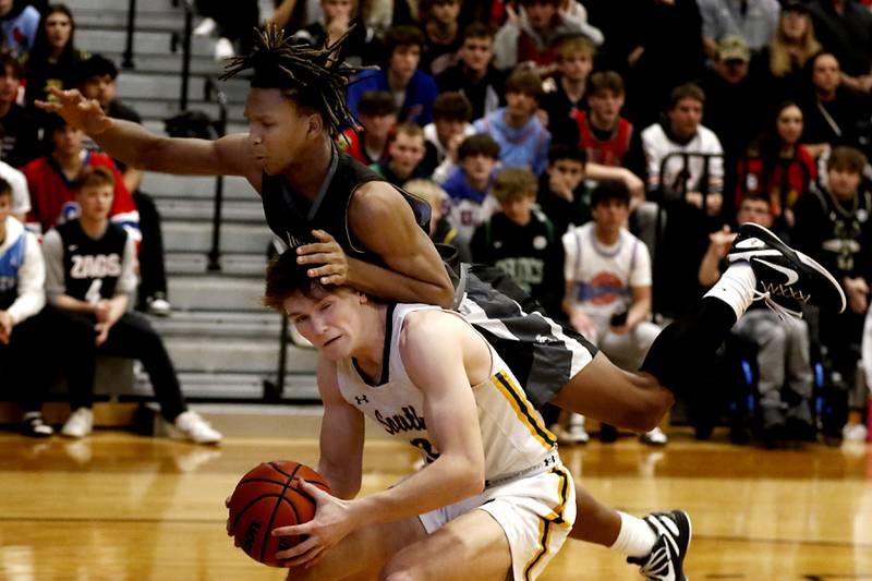 Kaneland's Isaiah Gipson lands on Crystal Lake South's Colton Hess as Hess fakes him out during the IHSA Class 3A Kaneland Boys Basketball Sectional championship game on Friday, March 1, 2024, at Kaneland High School in Maple Park.