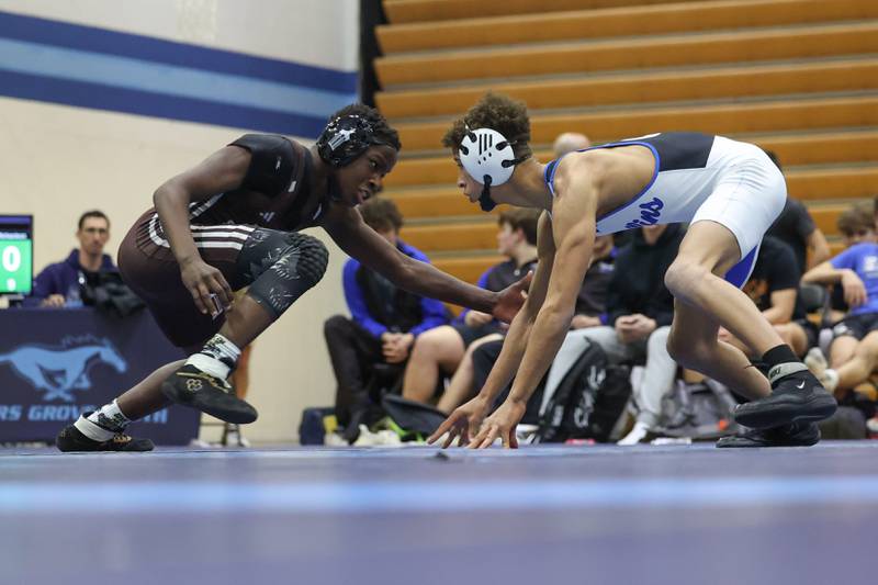 Joliet Catholic’s Adante Washington makes a move against Lincoln-Way East’s Kaidge Richardson in the Class 3A dual team sectional at Downers Grove South High School on Tuesday, Feb. 20th 2024.
