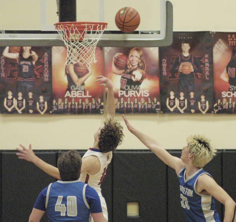 Morrison's Brenden Martin shoots ove Princeton's Noah Laporte during the Morrison vs Princeton class 2A basketball regional final at Prophetstown High School on Friday, Feb. 23 .