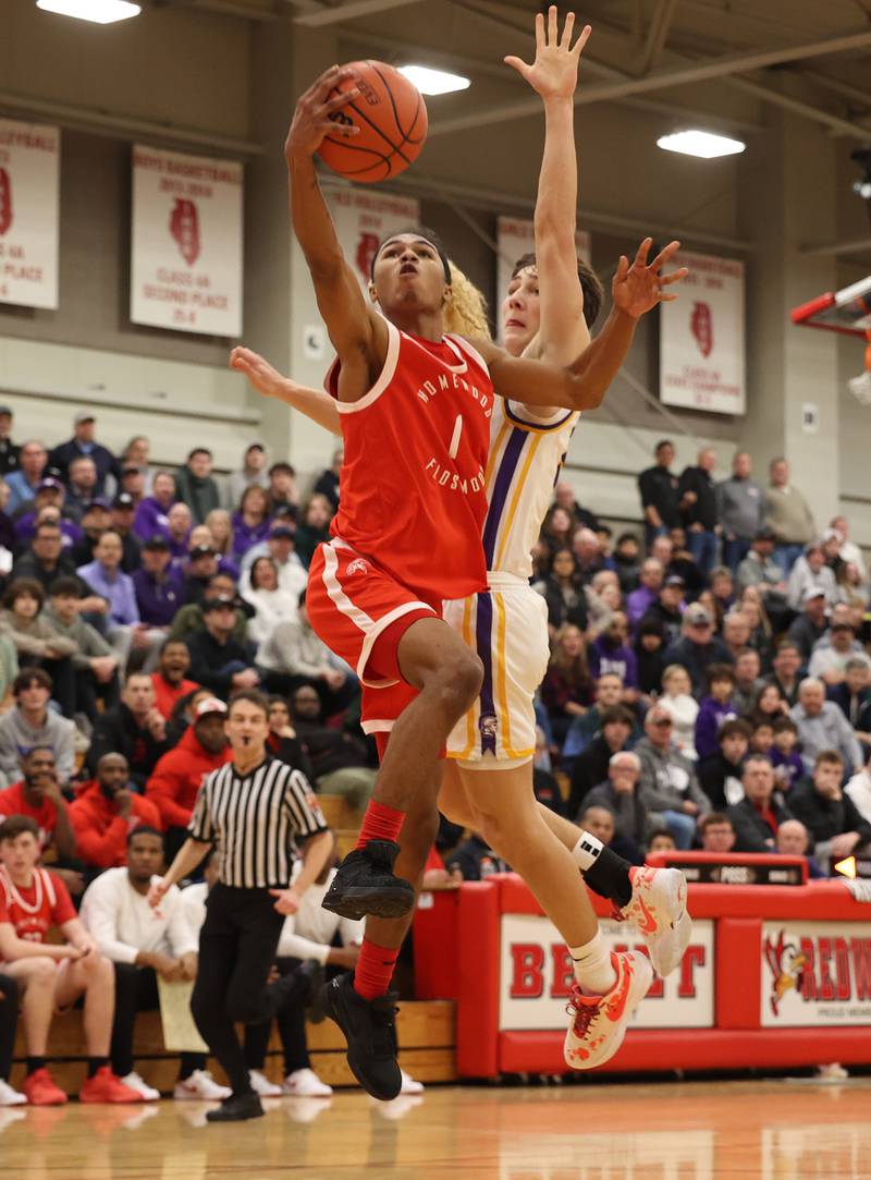 Downers Grove North’s Jack Stanton goes for the block against Homewood-Flossmoor’s Gianni Cobb (1) during the When Sides Collide Shootout on Saturday, Jan. 20, 2024 in Lisle, IL.