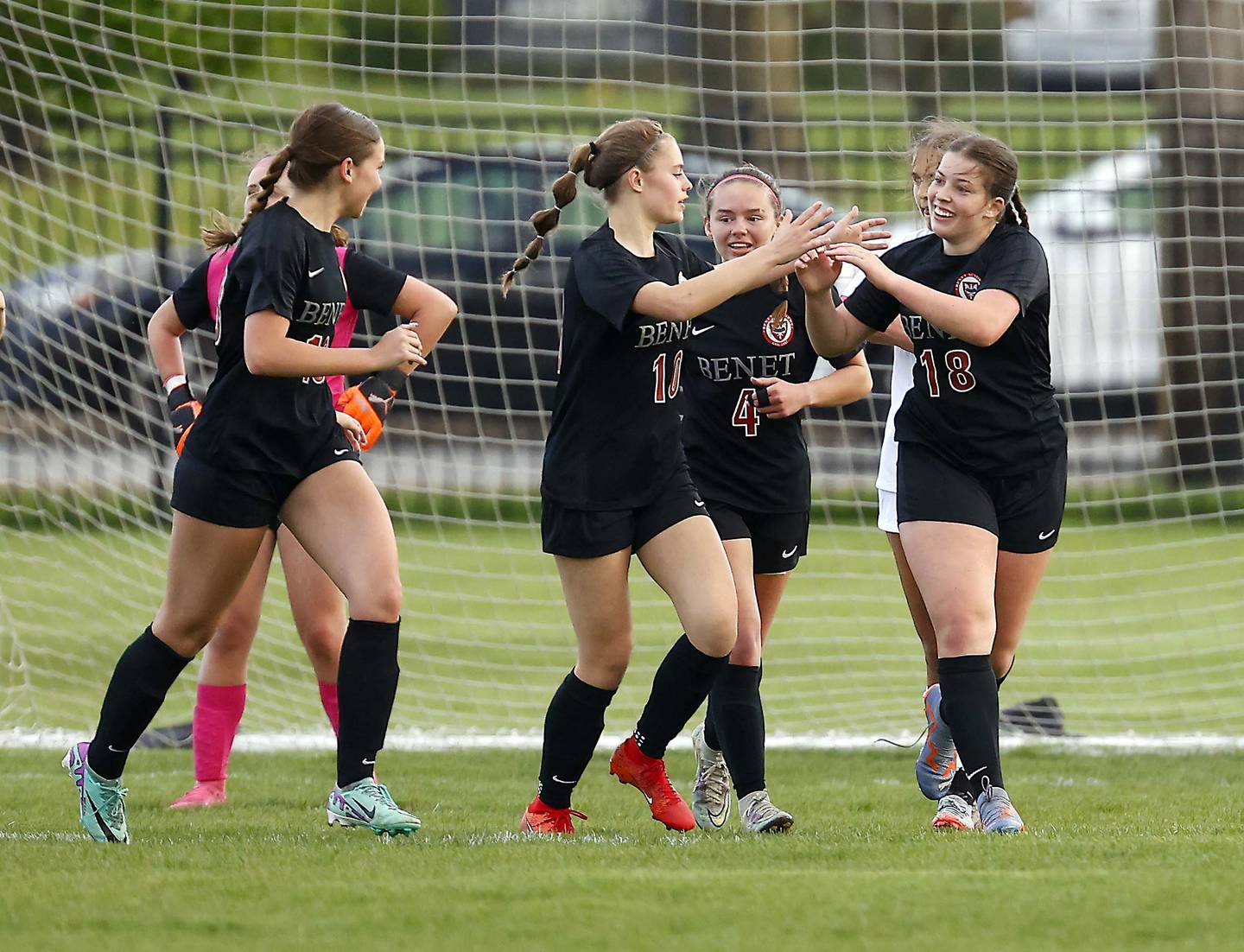 Benet’s Eleanor Mahan (18) is greeted by her teammates after a goal against St. Viator Tuesday, April 23, 2024 in Lisle.