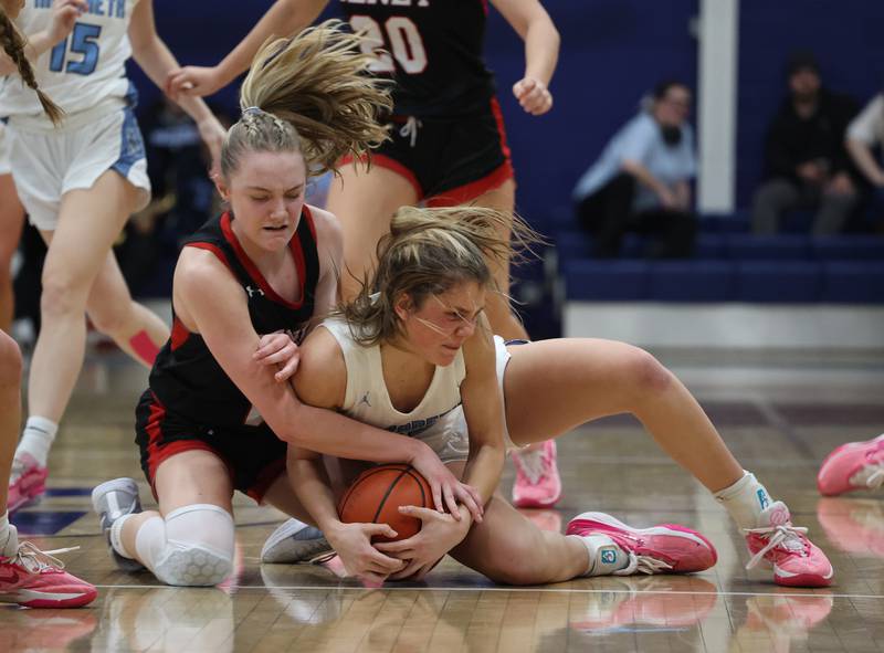 Benet’s Bridget Rifenburg (22) and Nazareth’s Stella Sakalas (32) fight for a loose ball during a girls varsity basketball game on Monday, Jan. 29, 2024 in La Grange Park, IL.