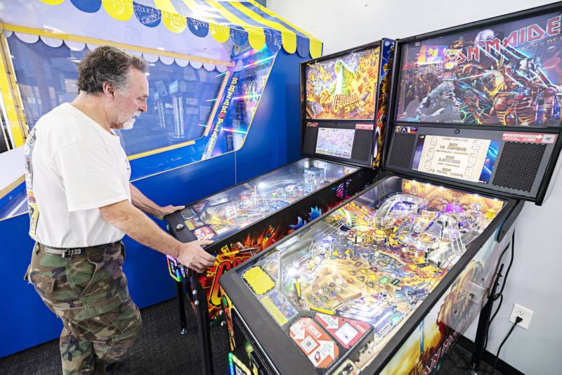 Steven “Kojack” Kovach works a Godzilla pinball machine Tuesday, Nov. 7, 2023 at Bugsy’s in Sterling. Kojack is a regular at the arcade.