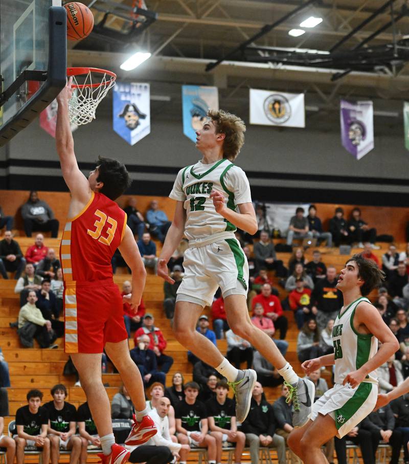 York’s Brendan Molis, right, defends a shot by Batavia’s Ben Fiegel during the Addison Trail Class 4A boys basketball sectional semifinal on Wednesday, Feb. 28, 2024 in Addison.