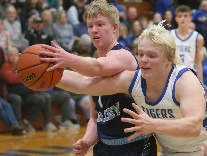 Bureau Valley's Bryce Helms and Princeton's Daniel Sousa reach to try to save the ball from going out of bounce on Tuesday, Jan. 30, 2024 at Princeton High School.