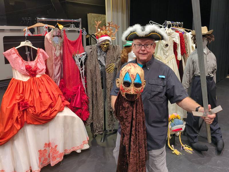 David Kuester, IVCC speech and theater professor, displays some of the costumes that will be available during the IVCC Theater Department’s vintage clothing sale next month. The three-day sale will be held on the college campus, with proceeds going to the student performing arts association.