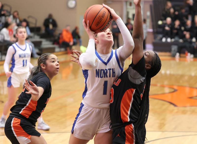 Wheaton North's Zoey Bohmer shoots over DeKalb’s Cayla Evans during their Class 4A regional game Monday, Feb 12, 2024, at DeKalb High School.