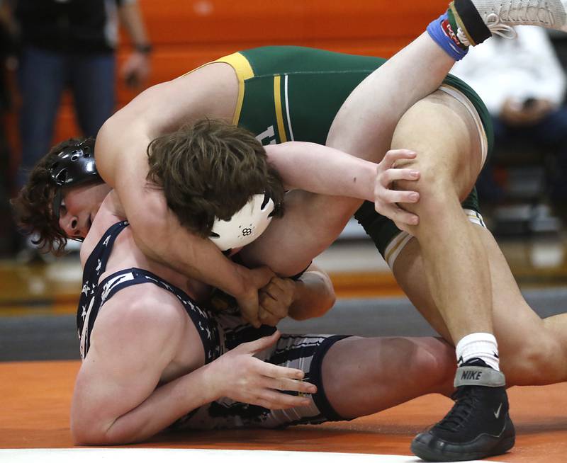 Crystal Lake South’s Caden Casimino tacks down Yorkvile Christian’s Jackson Allen  during the 175-pound championship match of a the IHSA 2A Crystal Lake Central Wrestling Regional on Saturday, Feb. 3, 2024, at Crystal Lake Central High School.