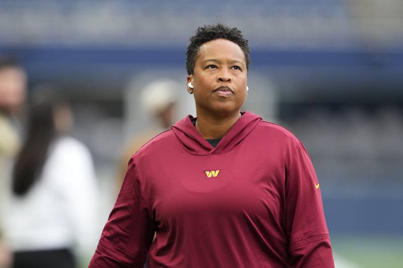 Washington Commanders assistant running backs coach Jennifer King walks on the field before an NFL football game against the Seattle Seahawks, Sunday, Nov. 12, 2023, in Seattle.
