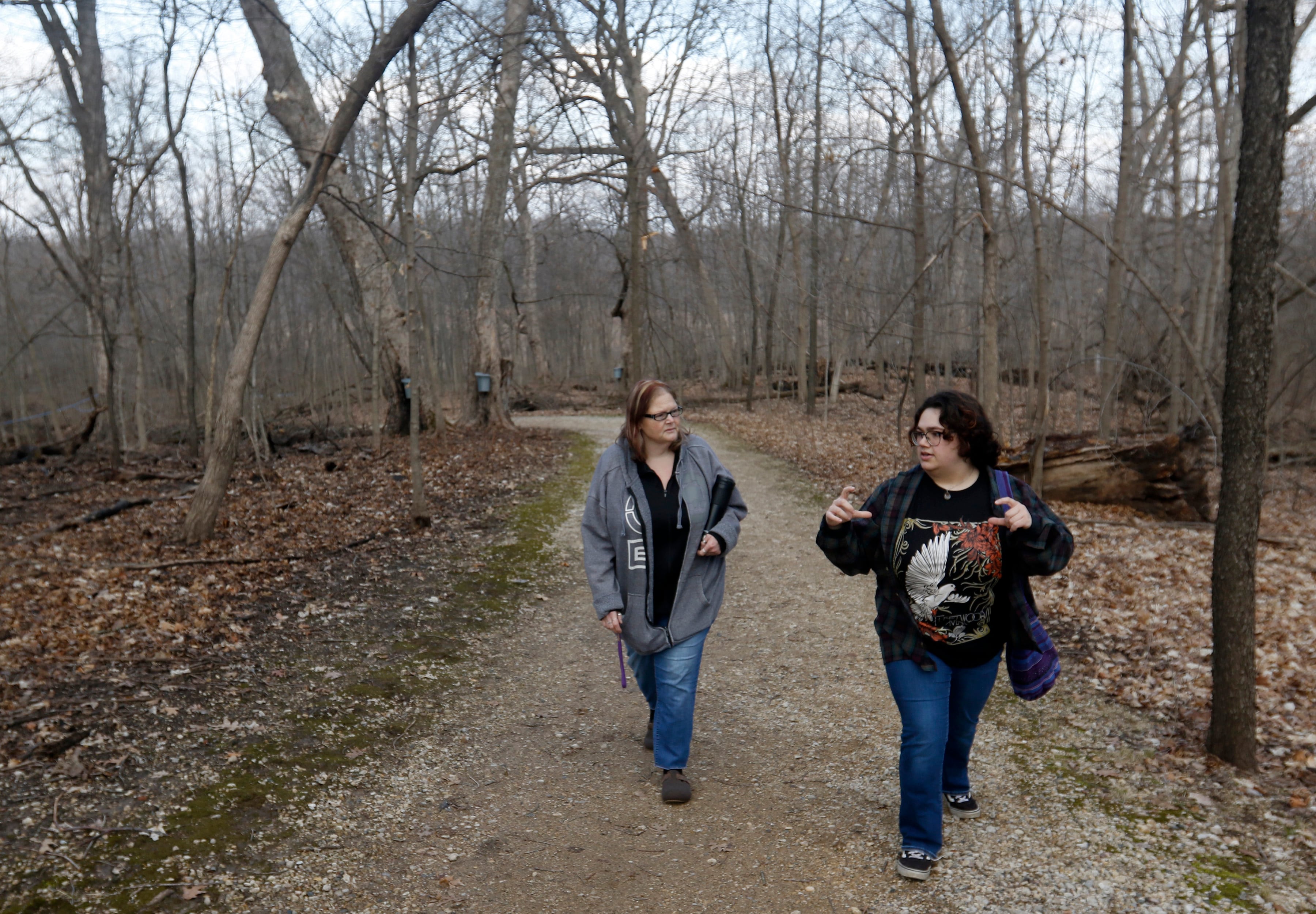 Fawn Vincent, of Wonder Lake, talks with her daughter, Reese, of Nashville, as they walk through the forest during the McHenry County Conservation District’s annual Festival of the Sugar Maples on Monday, March 6, 2023, at Coral Woods Conservation Area in Marengo.