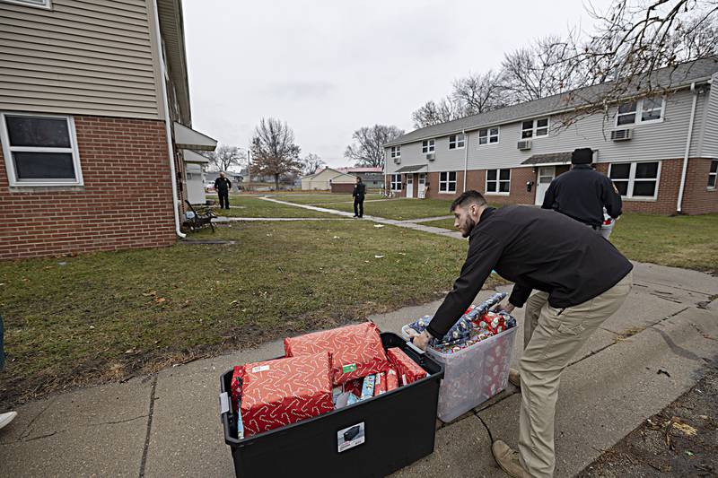 Gifts line up along the sidewalk as RFPD makes the first delivery of the day Friday, Dec. 22, 2023.