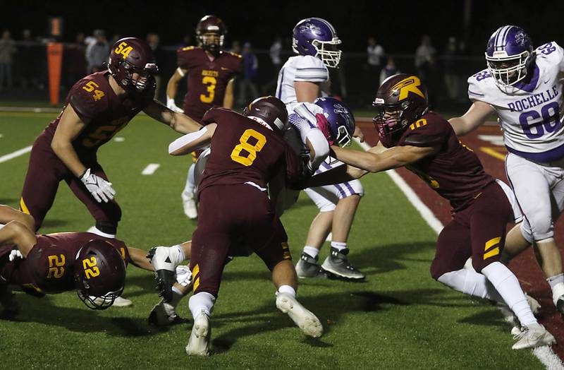 Richmond-Burton's Max Loveall (right) and Richmond-Burton's Jack Martens (second from right) \trie to keep Rochelle's Roman Villalobos out of the end zone during a Kishwaukee River Conference football game on Friday, Oct.20, 2023, at Richmond-Burton High School.