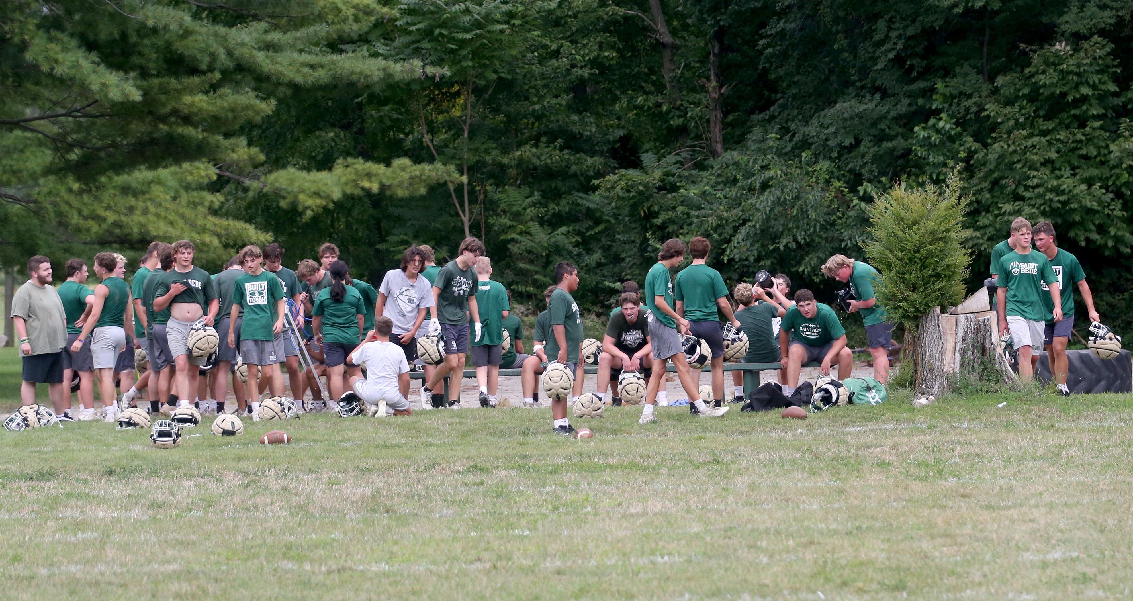 Members of the St. Bede football team take a water break during the first day of football practice on Monday, Aug. 12, 2024 at St. Bede Academy.