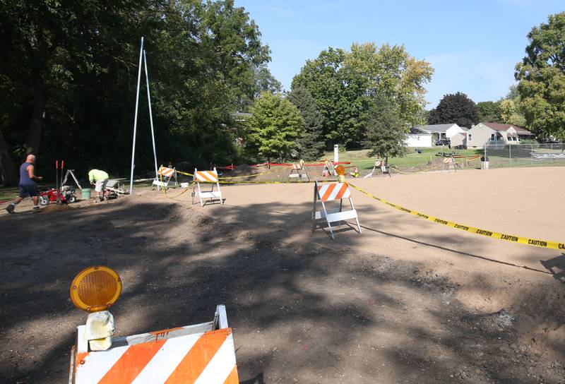 Workers from Illinois Valley Fence and Pool are building a new fence around the perimeter of the baseball field on Wednesday, Sept. 18, 2024 at Sunset Park in Peru.