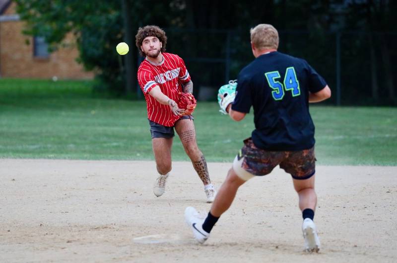 Malden Methodist short stop Josh Riordan tosses to second baseman Matt Hayes for a force out in Tuesday's Princeton Park District Fastpitch tournament championship action.