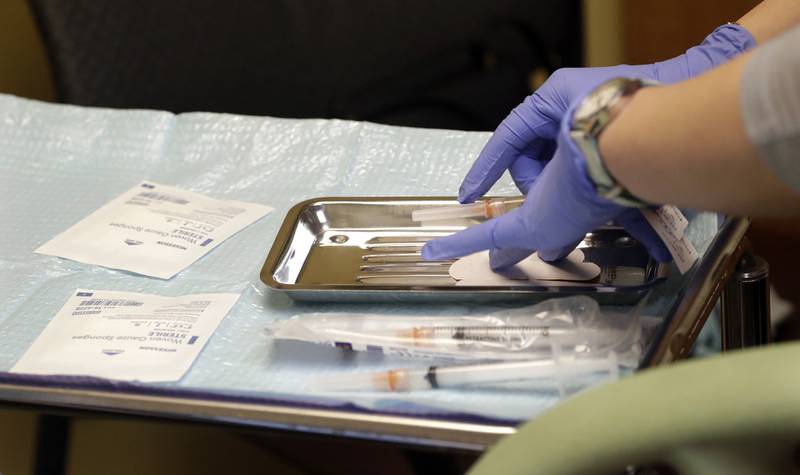 A health care worker prepares syringes, including a vaccine for measles, mumps, and rubella (MMR), for a child's inoculations at the International Community Health Services Wednesday, Feb. 13, 2019, in Seattle. A recent measles outbreak has sickened more than 50 people in the Pacific Northwest, most in Washington state and, of those, most are concentrated in Clark County, just north of Portland, Oregon. Washington Gov. Jay Inslee declared a state of emergency over the outbreak last month.