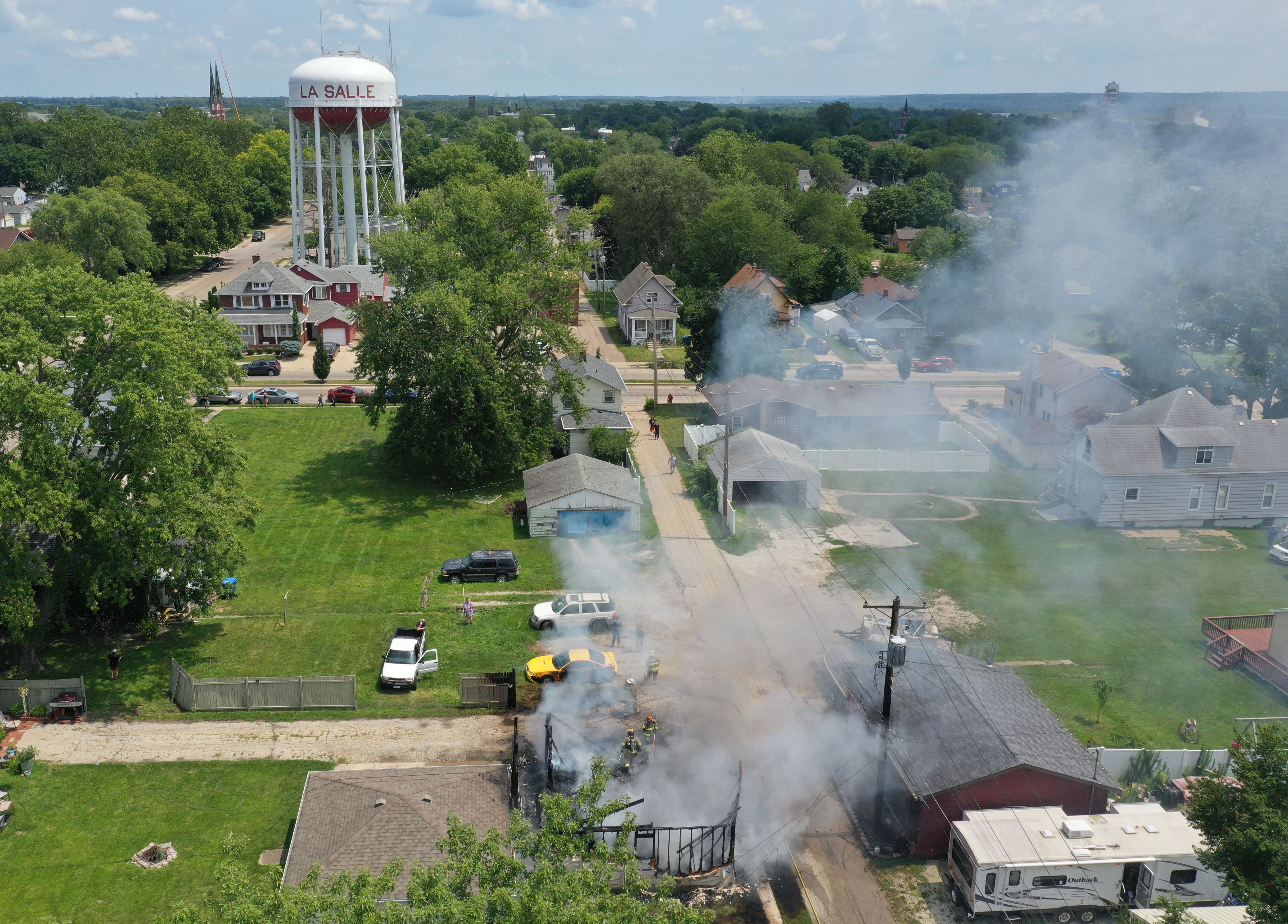 La Salle and Peru firefighters work the scene of garage fire in the 800 block of Lafayette Street on Monday, July 22, 2024. The fire began just before 1p.m. La Salle Fire and EMS along with Peru Fire department responded to the call while La Salle Police directed traffic.