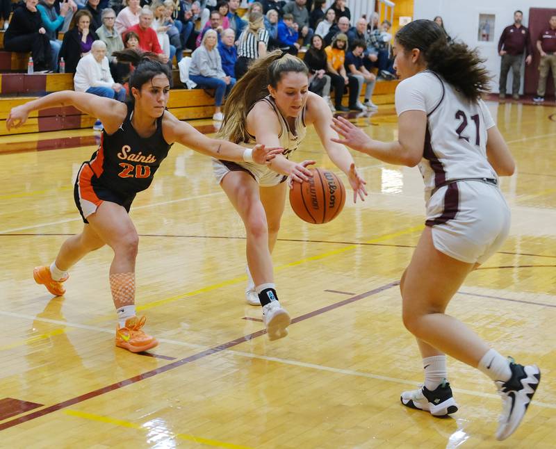 St. Charles East's Alexis Maridis (20) and Montini's Shea Carver and Alyssa Epps (21) close in on a loose ball during the Montini Christmas Tournament championship game on Dec. 29, 2023 at Montini Catholic High School in Lombard.