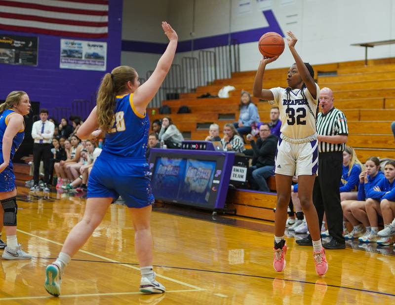 Plano's Nylah Mathews (32) shoots a three pointer against Johnsburg's Kiara Welch (20) during a basketball game at Plano High School on Tuesday, Jan 30, 2024.