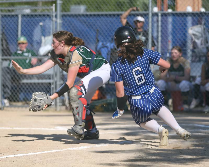 Newark's Cali Beyer (6) slides into home to score the first run of the game during Class 1A Newark Regional final game between St. Edwards at Newark. May 17th, 2024.