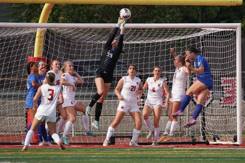 Hinsdale Central's Emeline McClenahan (99) goes up high for a save against Lyons' during a Class 3A Hinsdale Central Sectional semifinal soccer match at Hinsdale Central High School in Hinsdale on Tuesday, May 21, 2024.