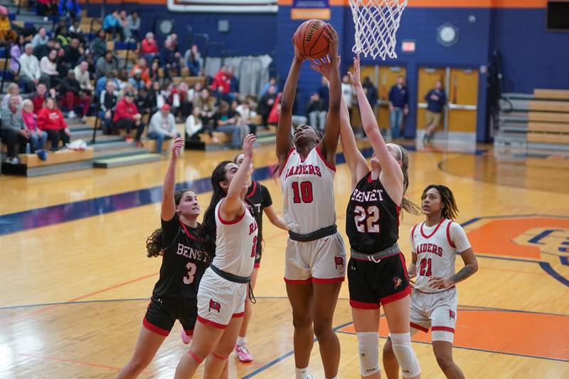 Bolingbrook's Trinity Jones (10) rebounds the ball over Benet’s Bridget Rifenburg (22) during a Oswego semifinal sectional 4A basketball game at Oswego High School on Tuesday, Feb 20, 2024.