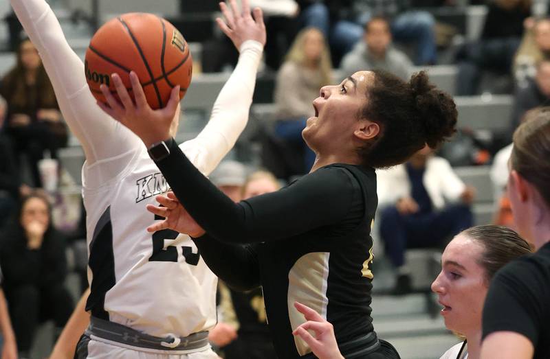 Sycamore's Monroe McGhee goes to the basket against Kaneland's Kendra Brown during their game Wednesday, Jan. 10, 2024, at Kaneland High School in Maple Park.