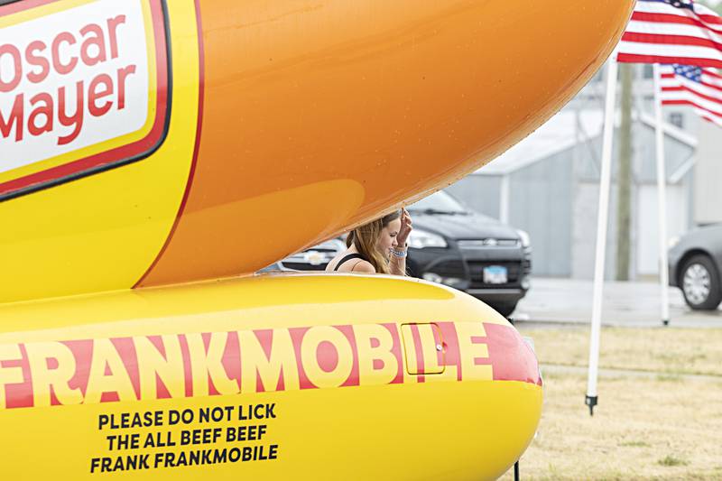 Addyson Mullesch, 12, has her picture taken by grandma Lori Mullesch Friday, June 30, 2023 in front of the Oscar Mayer Frankmobile. The mobile sausage made a stop in Rock Falls to celebrate the fun of Fourth of July.