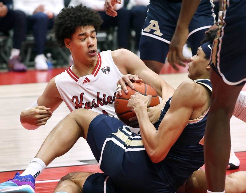 Northern Illinois' Yanic Konan Niederhauser and Akron’s Enrique Freeman fight for a loose ball during their game Tuesday, Jan. 2, 2024, in the Convocation Center at NIU in DeKalb.