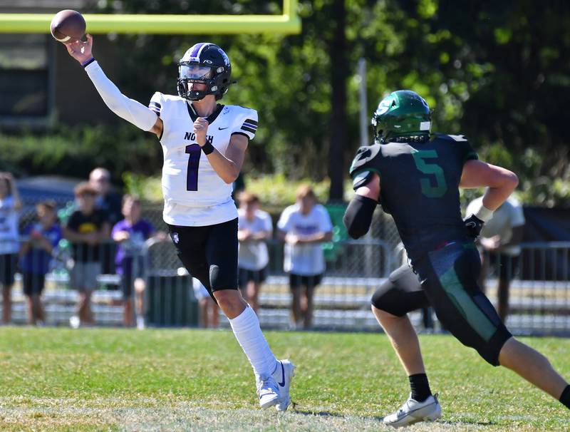 Downers Grove North quarterback Owen Lansu (1) releases a pass as Glenbard West's Ben Starmann (5) closes in during a 2023 game at Glenbard West High School in Glen Ellyn.
Jon Cunningham for Shaw Local News Network