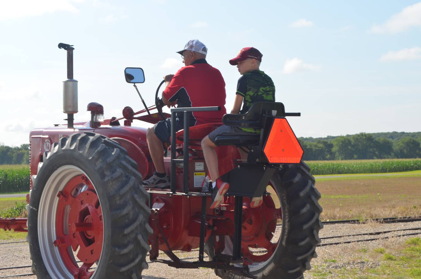 Robert Wilcox and his grandson, Jonathan Shannon, 11, of Sterling ride together in the Antique Engine and Tractor Association annual Tractor Ride for the club